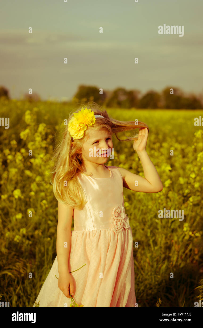 beautiful little girl in yellow field Stock Photo - Alamy
