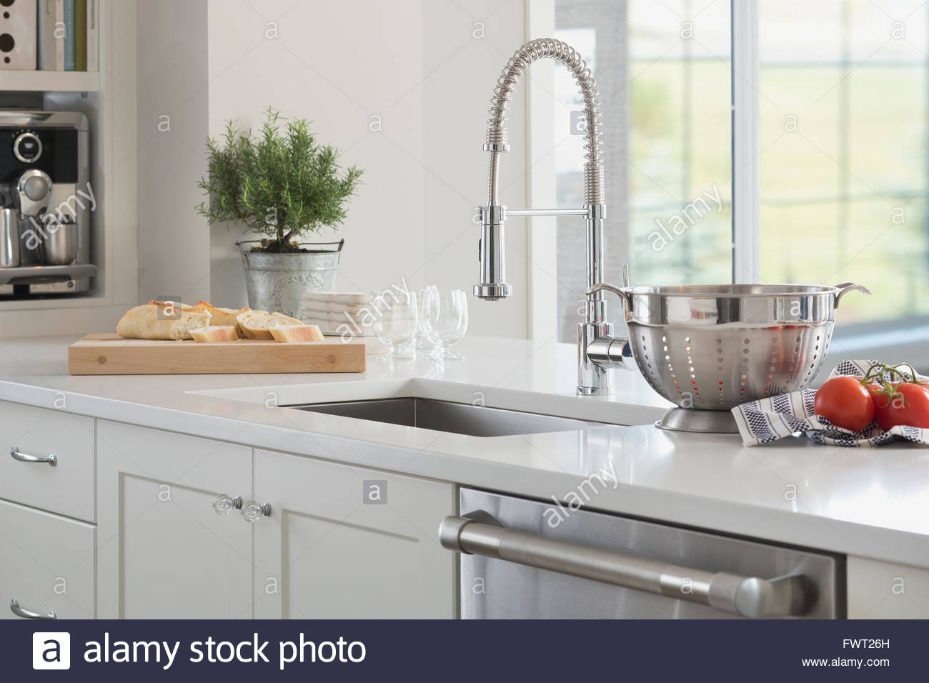 Gooseneck spring faucet in domestic kitchen Stock Photo