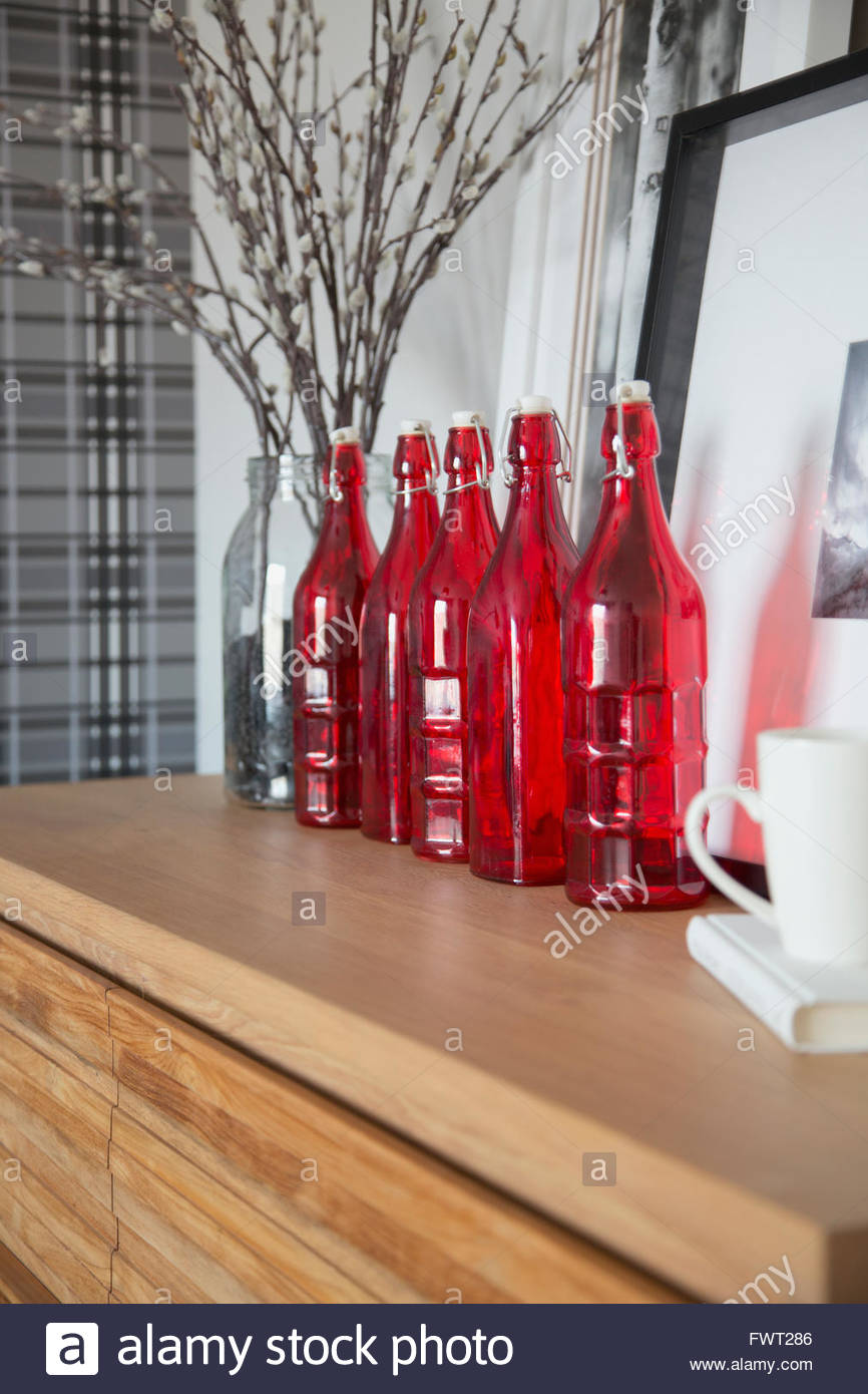 Red glass accent bottles on counter Stock Photo