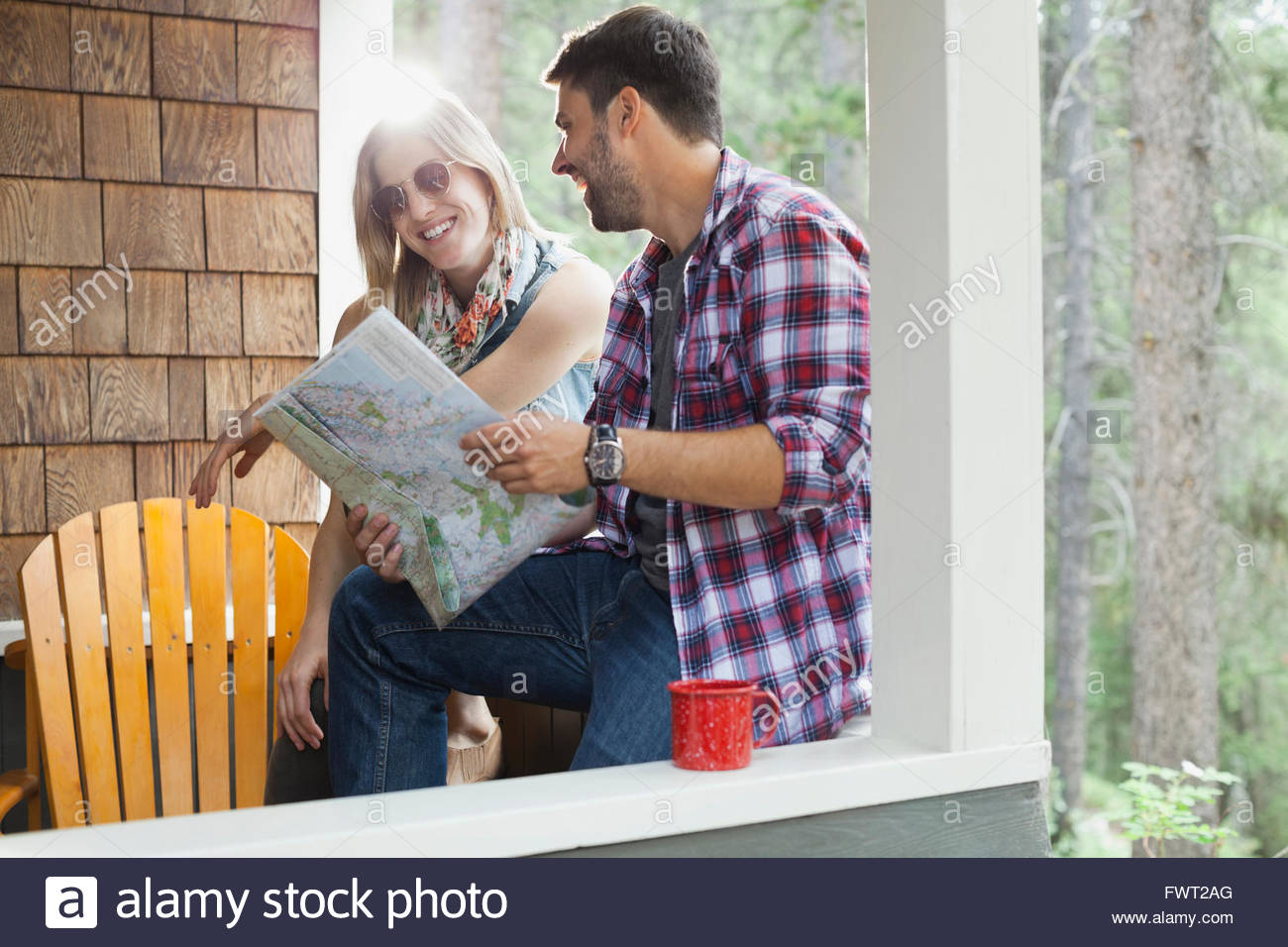 Couple sitting on cabin porch hi-res stock photography and images - Alamy