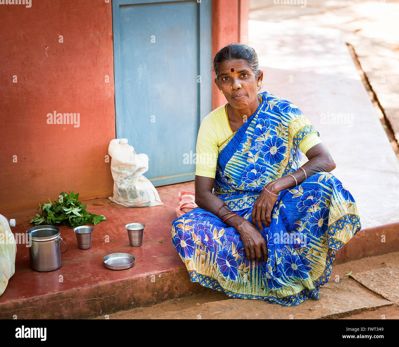 One lady having lunch on the route to the Matrimandir, at Auroville, in Viluppuram district in the state of Tamil Nadu Stock Photo