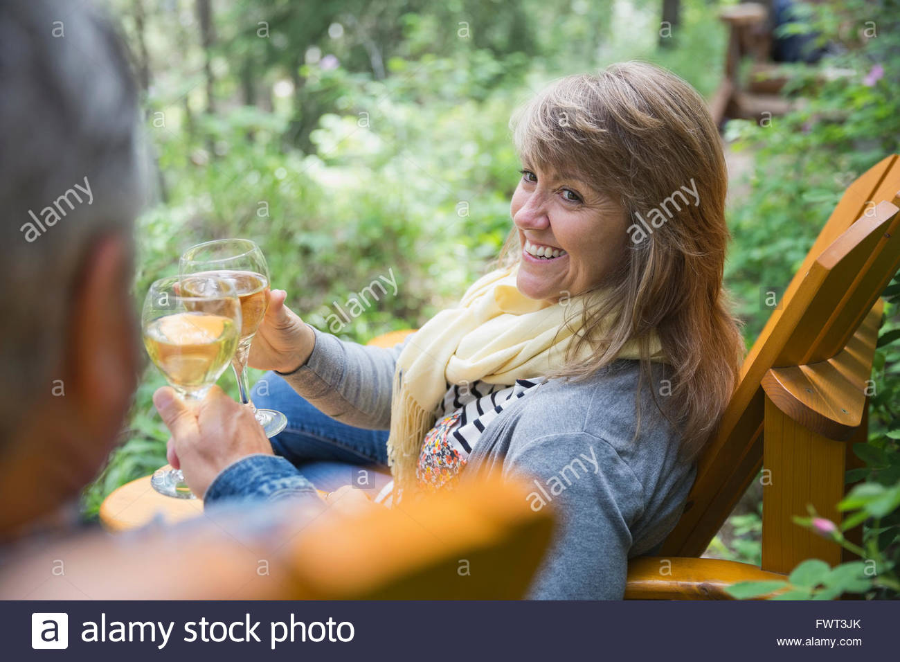 Middle-aged woman drinking wine outdoors Stock Photo