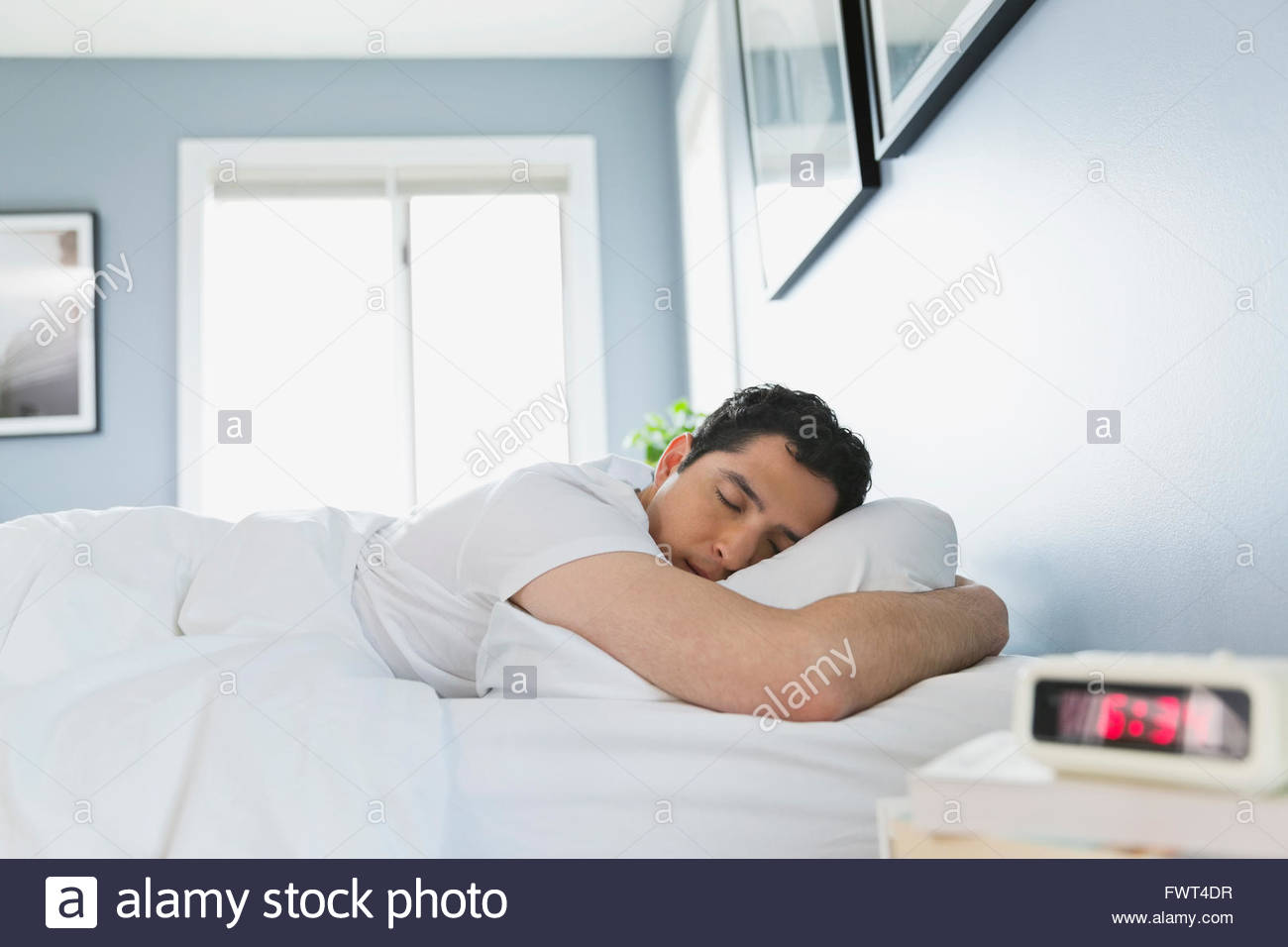 Side view of young man sleeping in bed Stock Photo Alamy