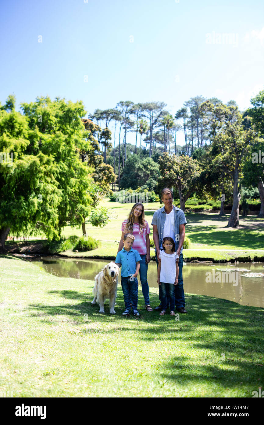 Happy family standing in the park Stock Photo - Alamy