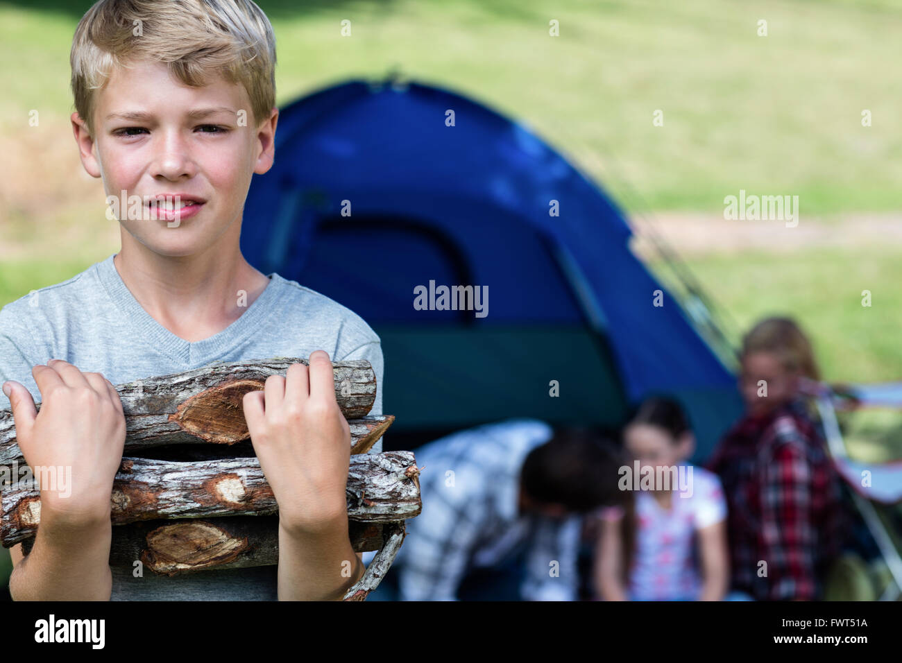 Boy carrying firewood hi-res stock photography and images - Alamy