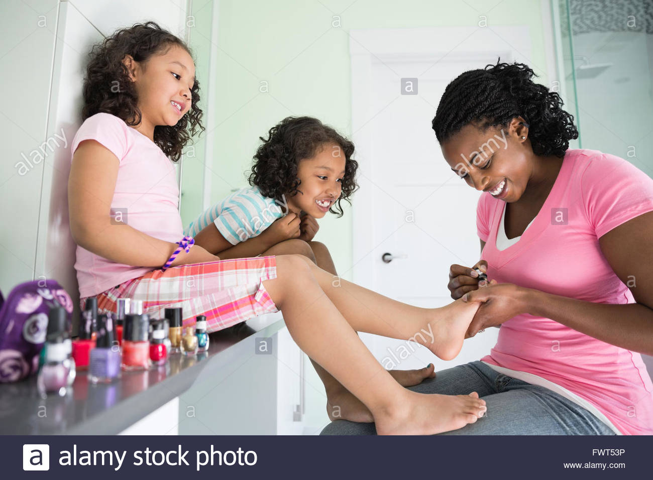 Mother painting young daughter's toenails Stock Photo Alamy
