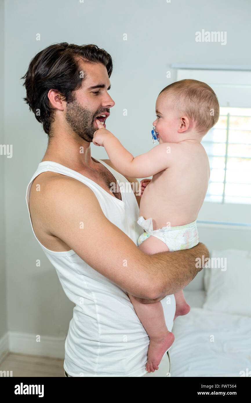 Father carrying playful boy Stock Photo