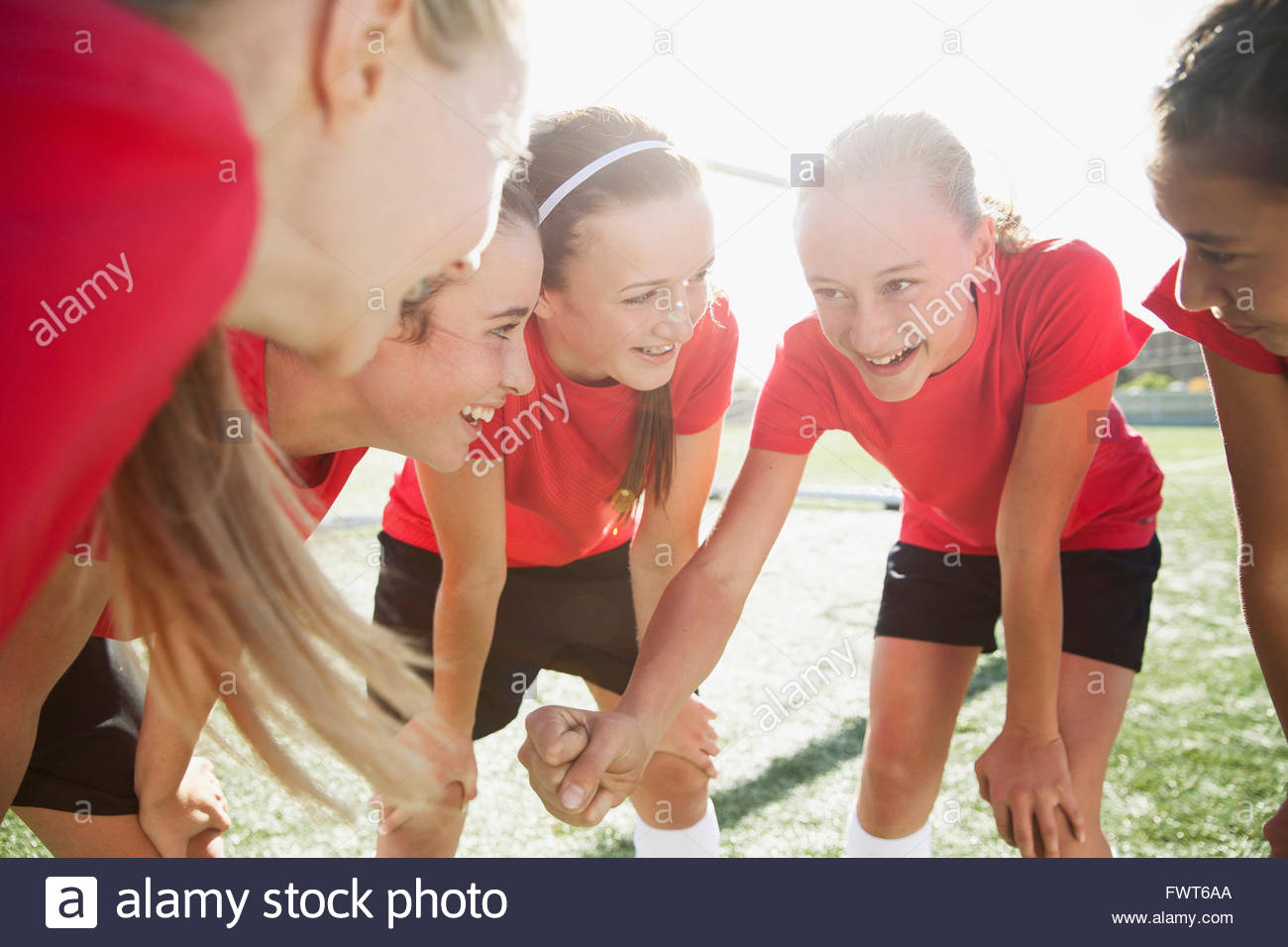 Girls soccer team doing hand over hand cheer Stock Photo Alamy