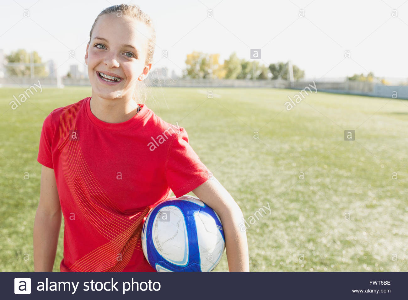 Girl soccer player holding soccer ball Stock Photo Alamy