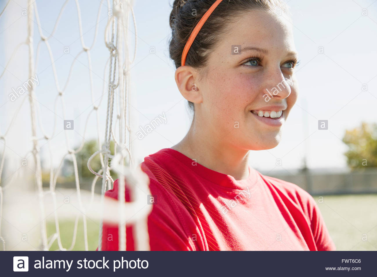 Teenage soccer girl standing by soccer net Stock Photo Alamy