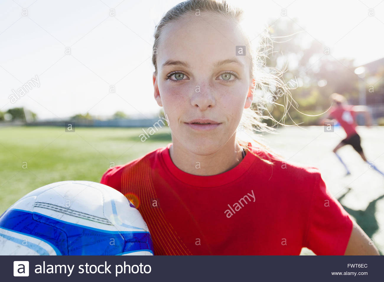 Girl soccer player holding soccer ball Stock Photo Alamy