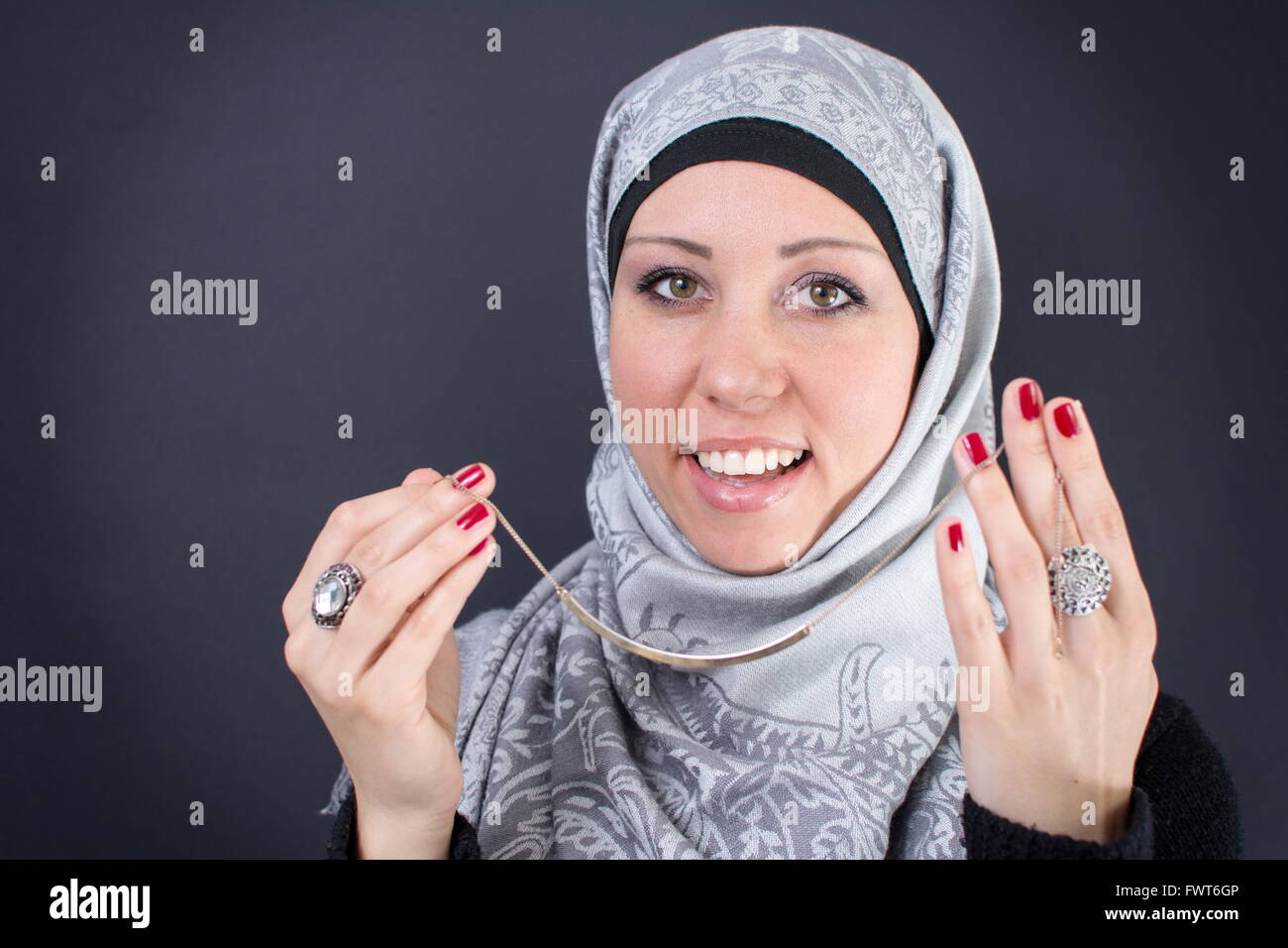 Beautiful muslim woman trying a necklace Stock Photo