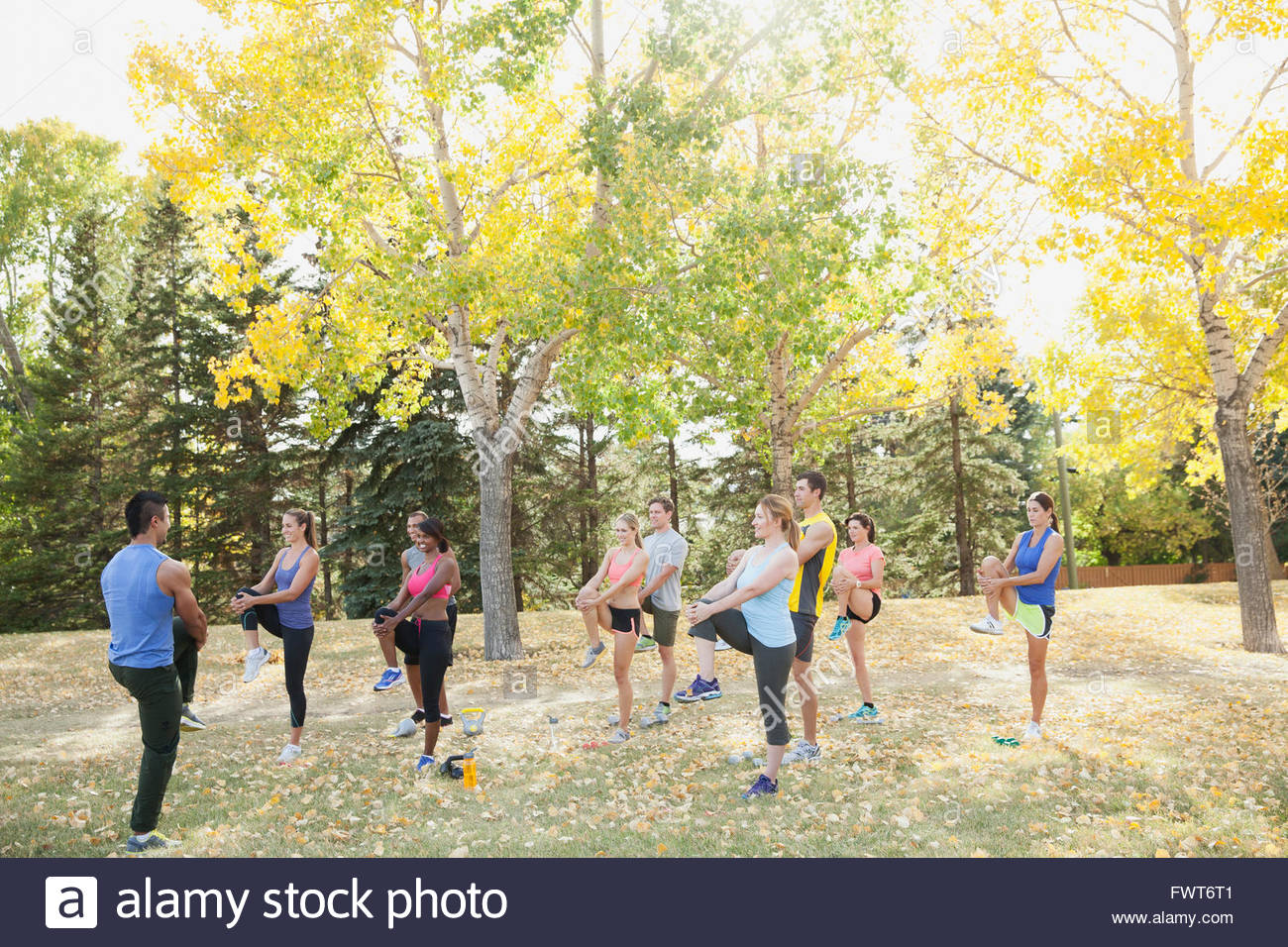 Outdoor fitness class stretching together Stock Photo Alamy