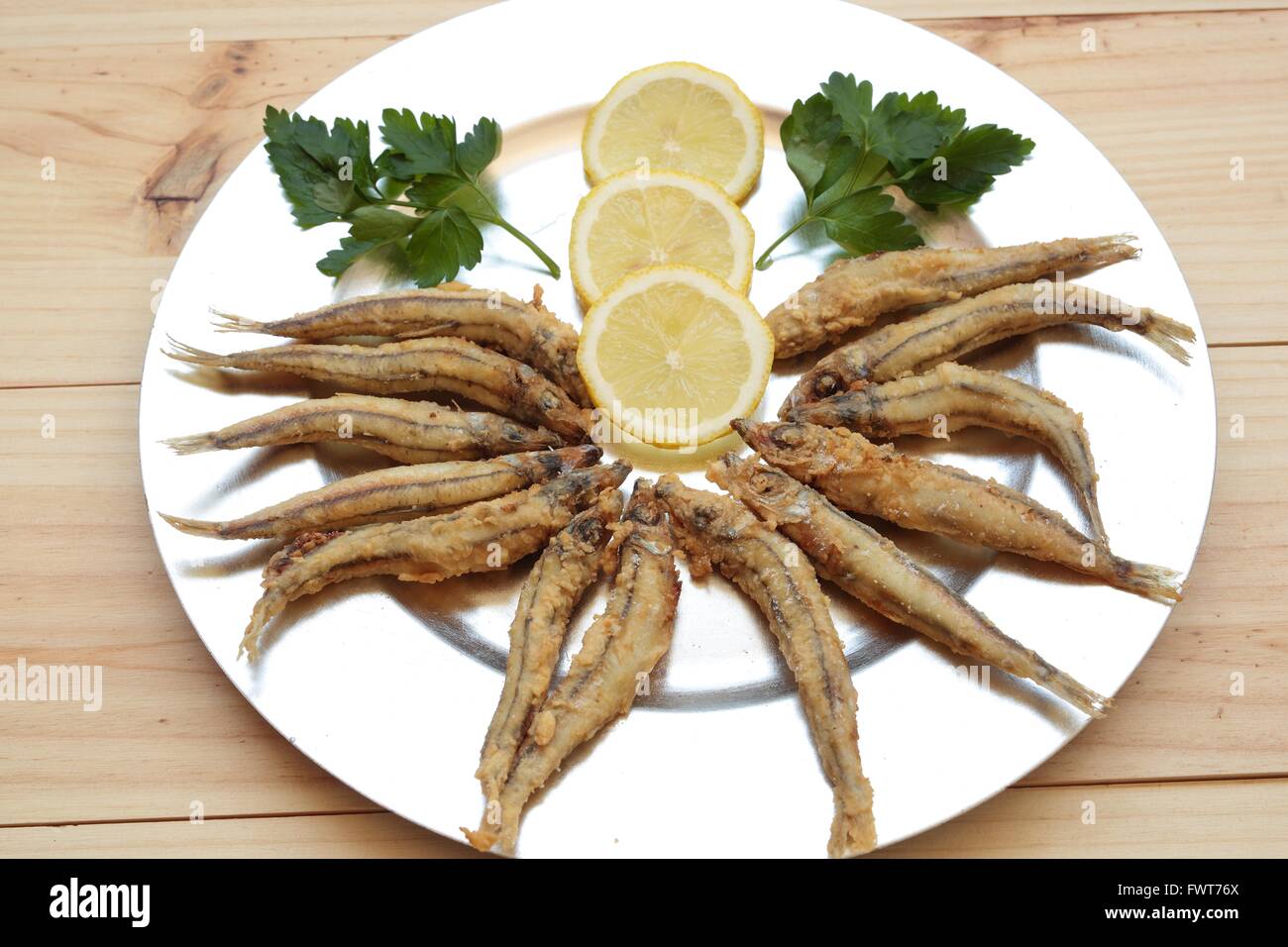 Fried fish with lemon on a silver tray Stock Photo