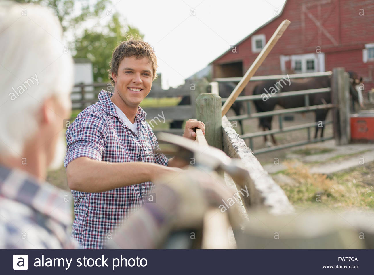 Father and son repairing fence on rural property Stock Photo Alamy