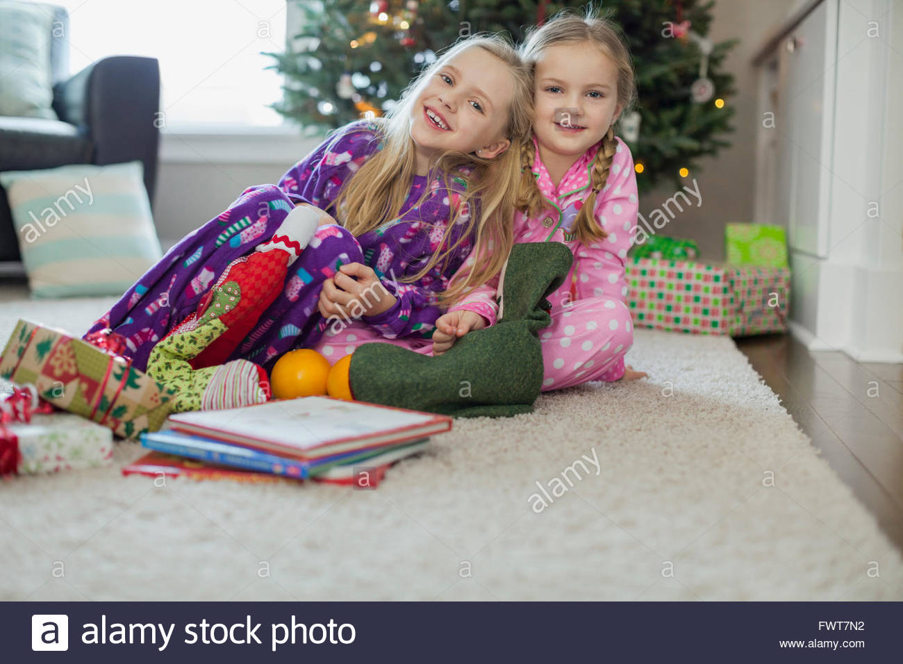 Girls opening Christmas stockings Stock Photo Alamy