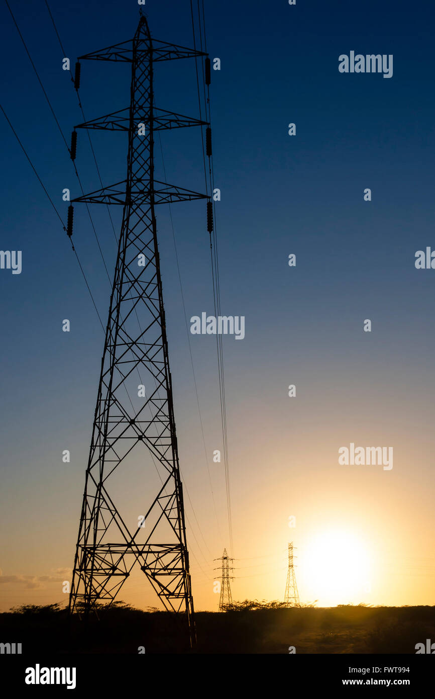 Silhouette of power lines and transmission towers at sunset Stock Photo ...