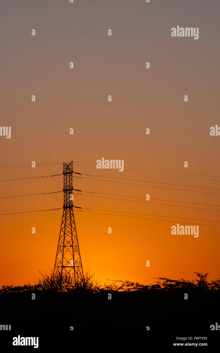 Silhouette of power lines and transmission towers at sunset Stock Photo ...