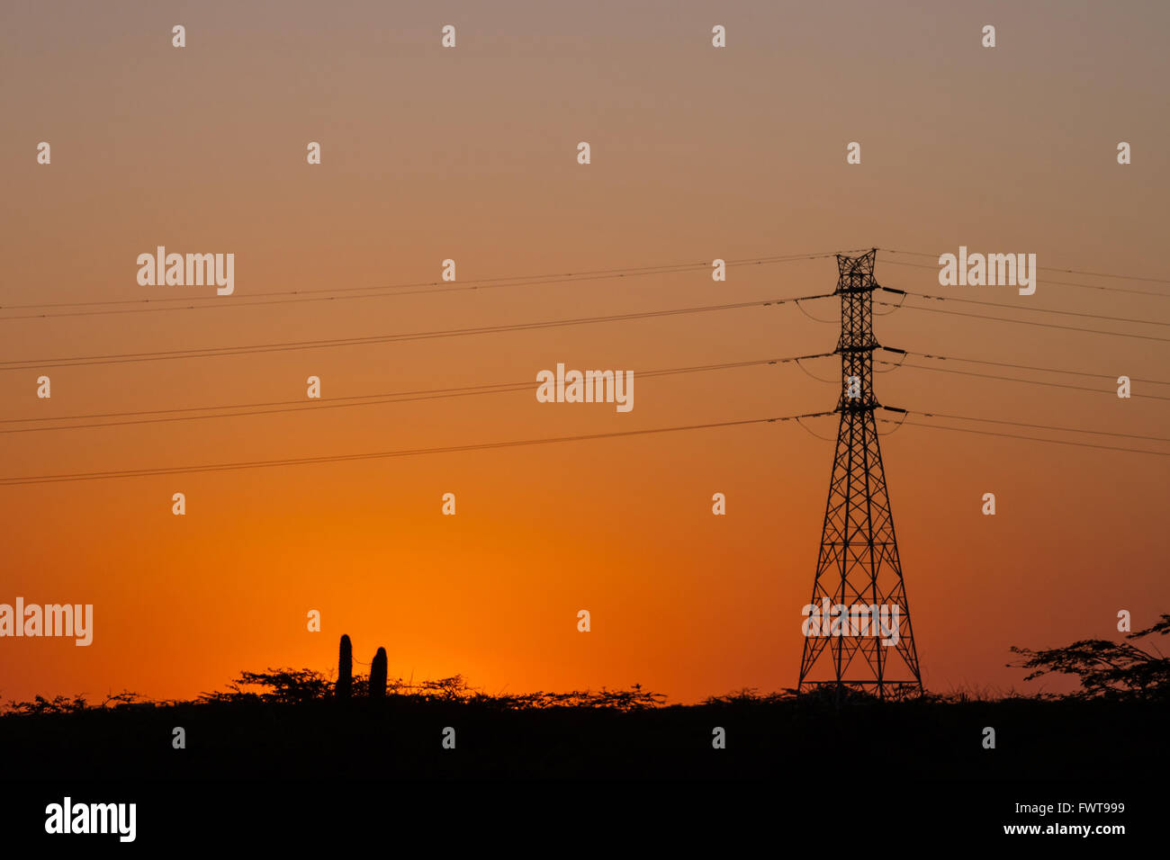 Silhouette of power lines and transmission towers at sunset Stock Photo ...