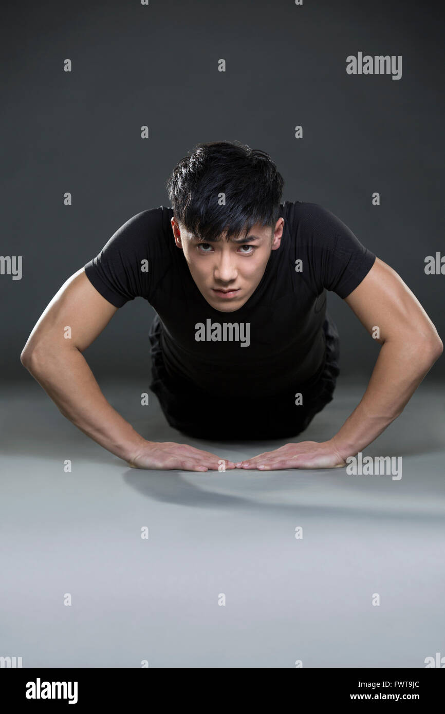 Young man doing push-ups Stock Photo - Alamy