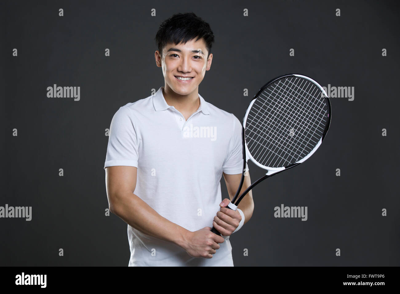 Young man holding tennis racket Stock Photo - Alamy