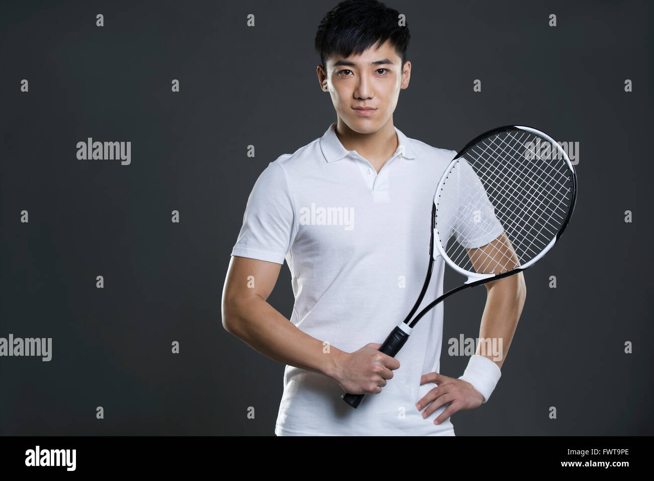 Young man holding tennis racket Stock Photo Alamy