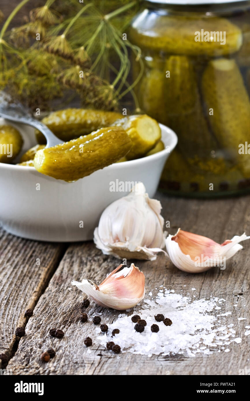 Ingredients for pickling cucumbers : garlic, black pepper, salt, dill on a wooden background Stock Photo