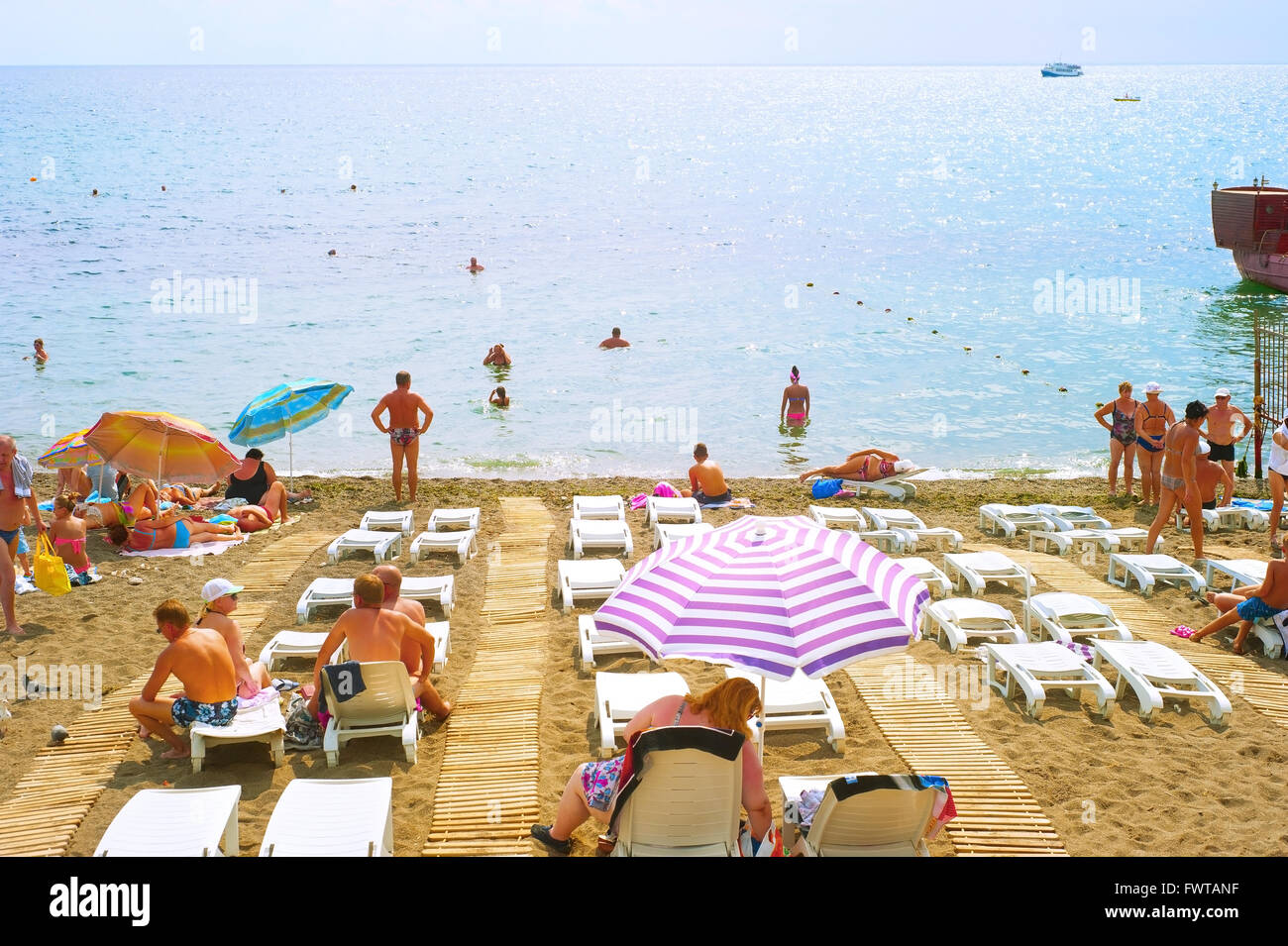 People at a sea beach in Sudak. Crimea Stock Photo