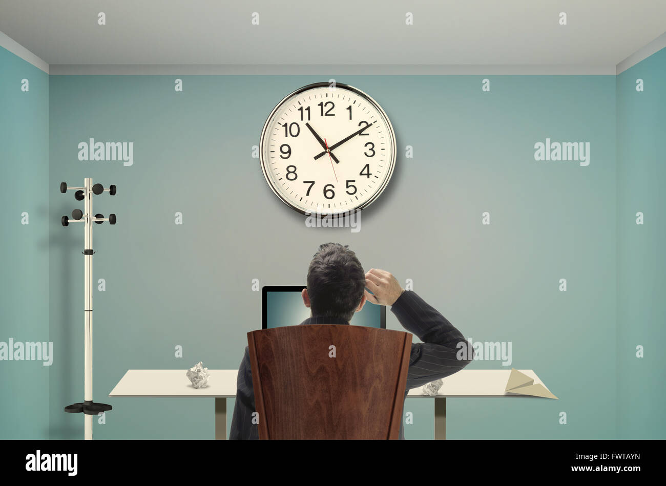 Relaxed businessman watching clocks Stock Photo