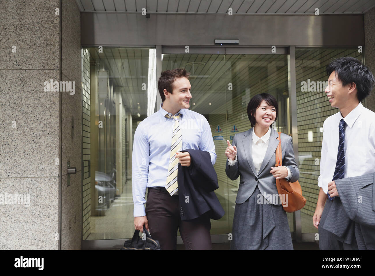 Multi-ethnic business people leaving the office Stock Photo