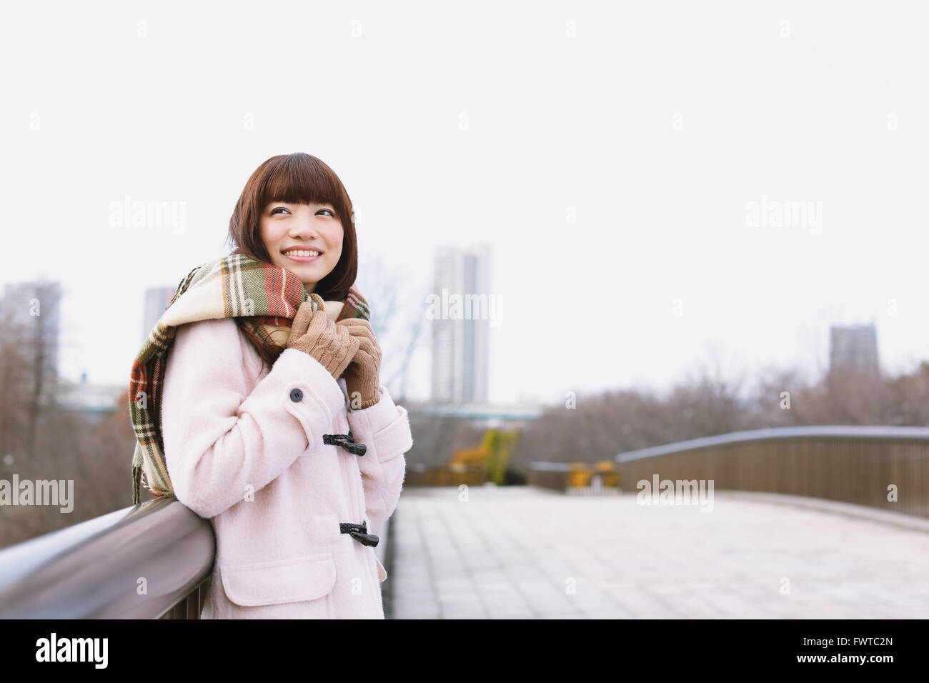 Attractive Japanese woman with muffler on a Winter sunny day Stock