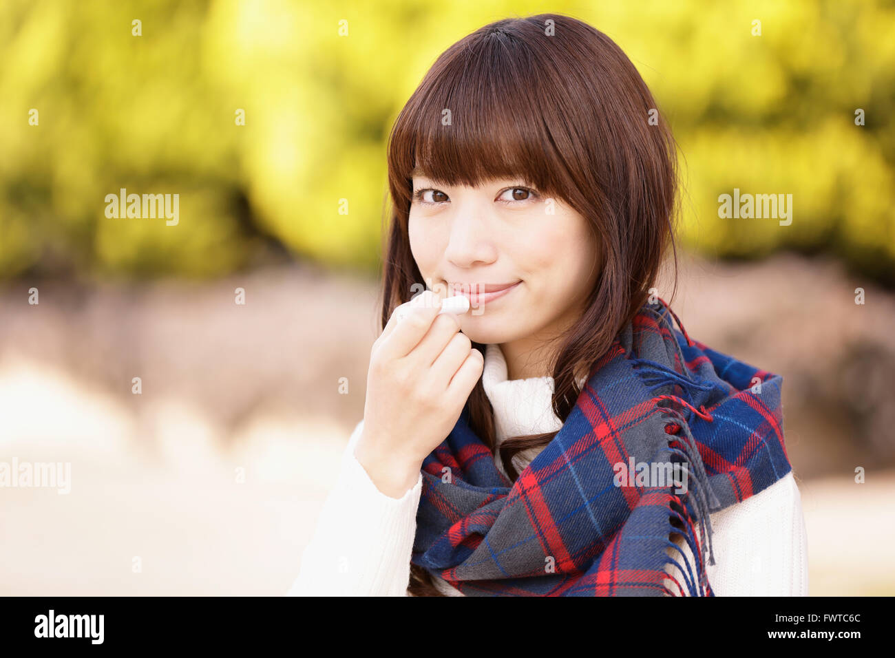 Attractive Japanese woman with muffler on a Winter sunny day Stock