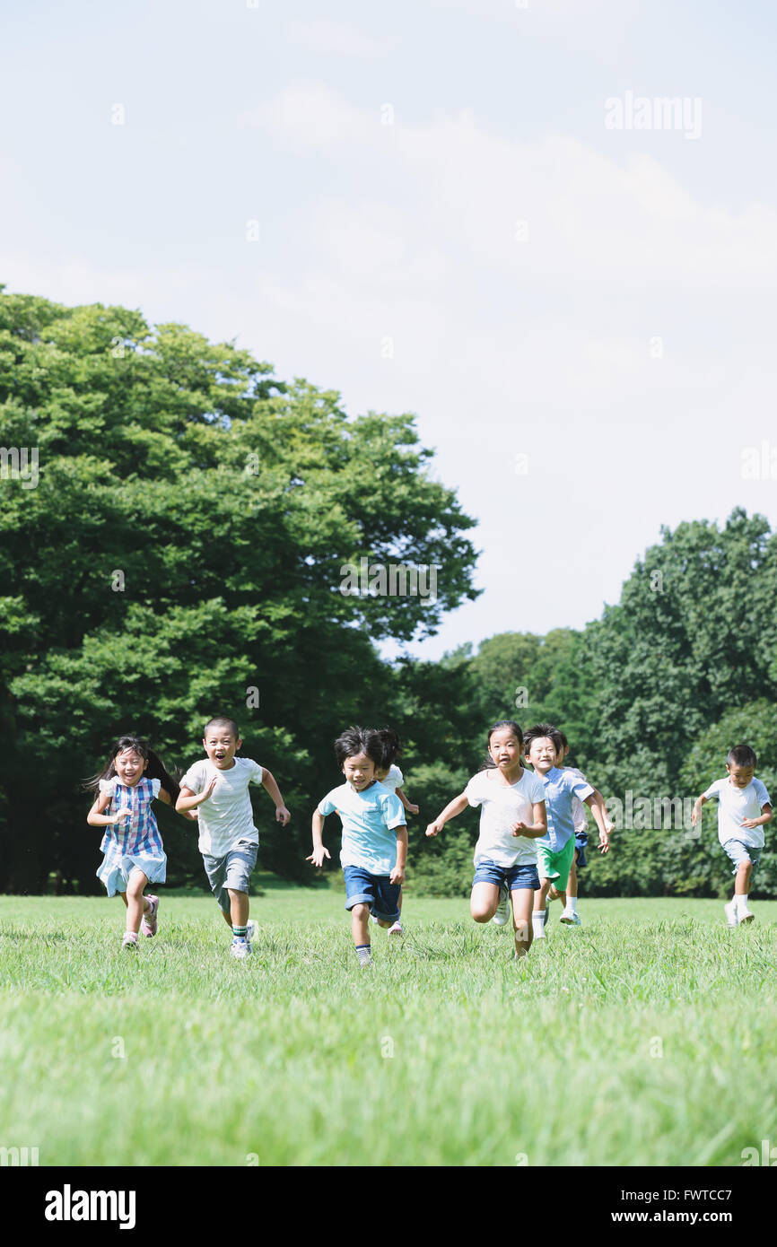Japanese kids running in a city park Stock Photo Alamy