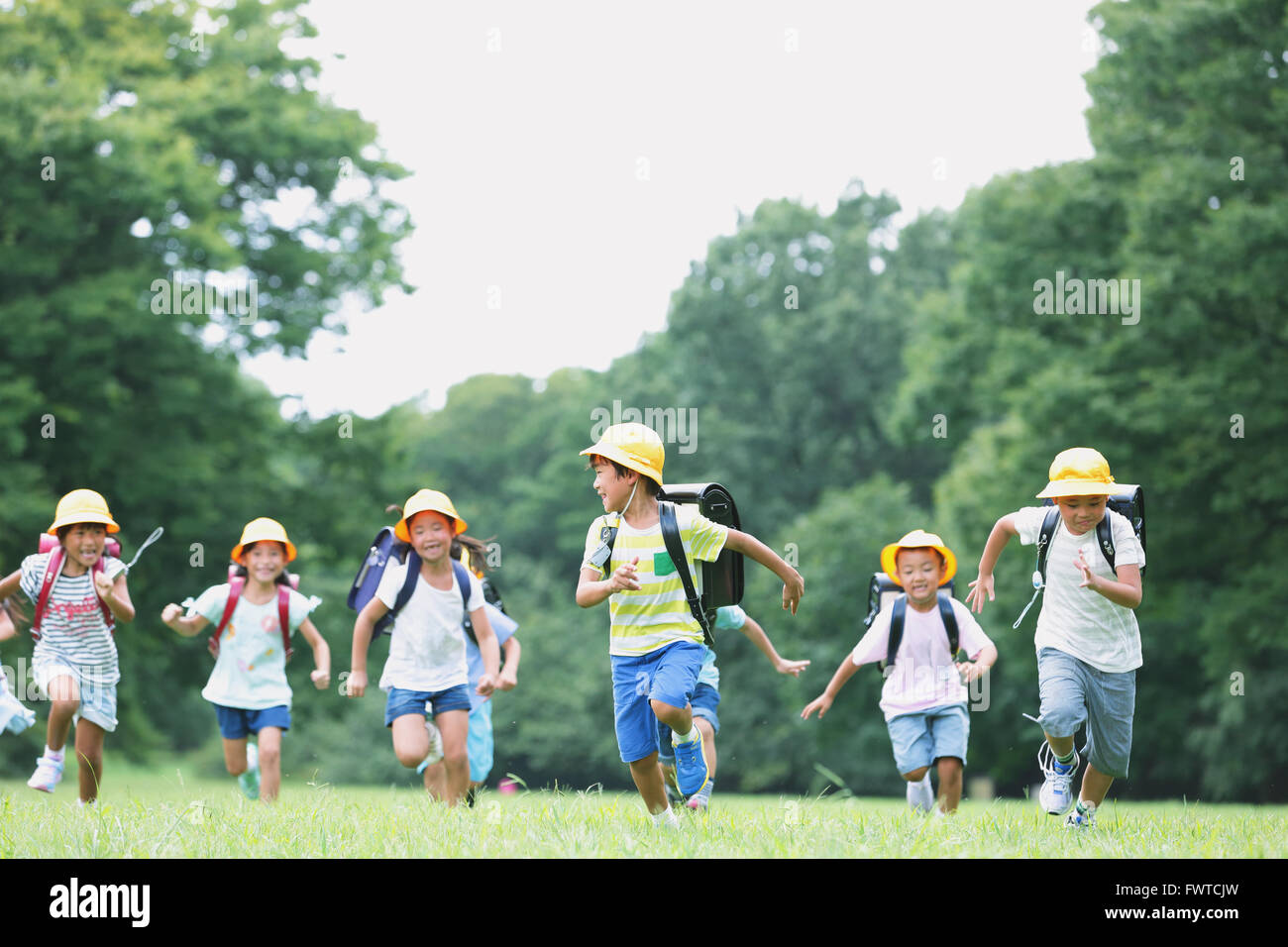 Japanese kids running in a city park Stock Photo Alamy