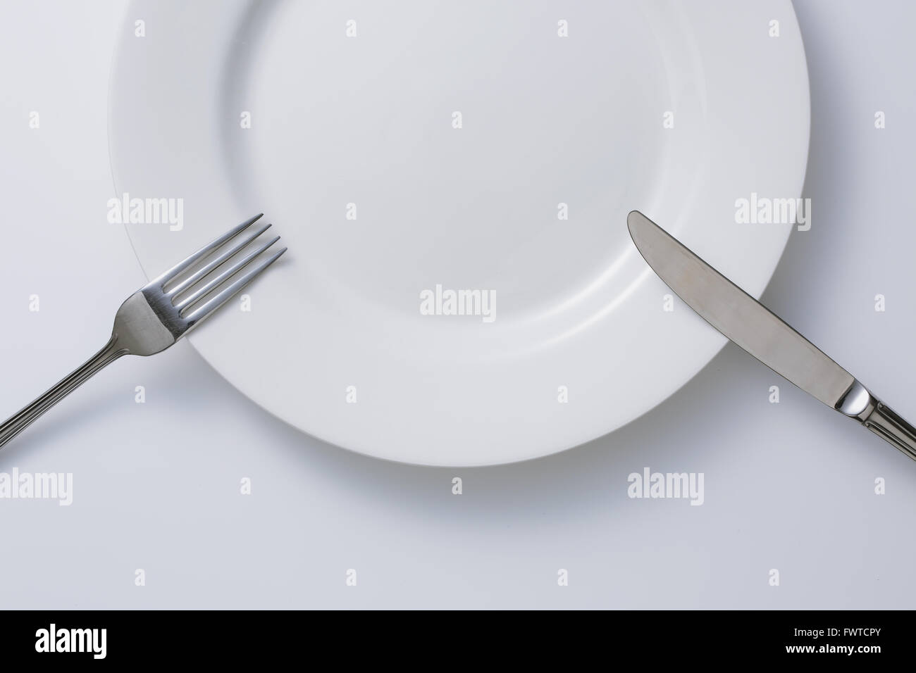 Empty plate and cutlery Stock Photo