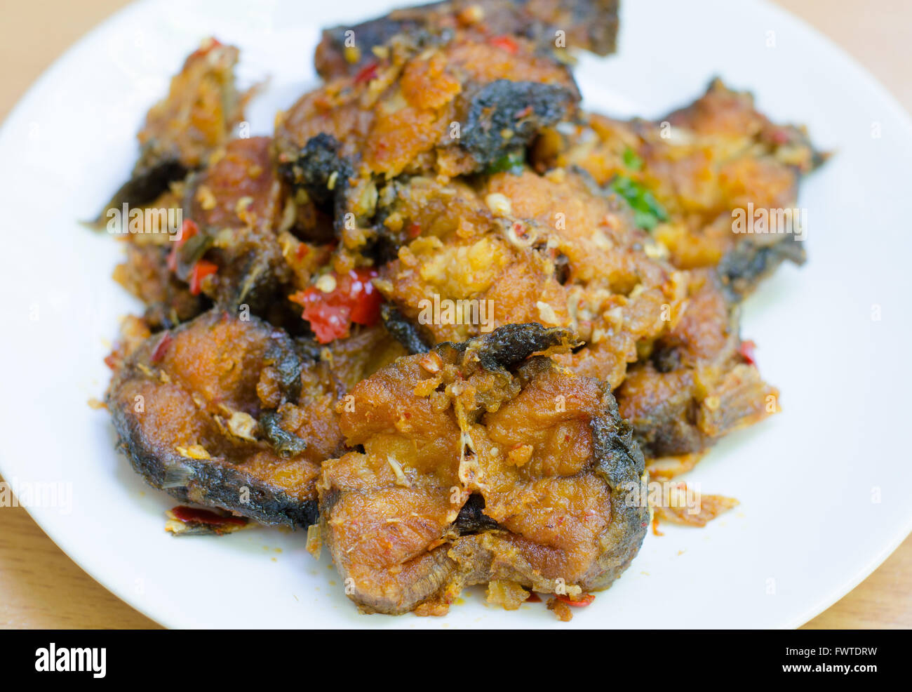 Spicy Stir Fried catfish on dish Stock Photo