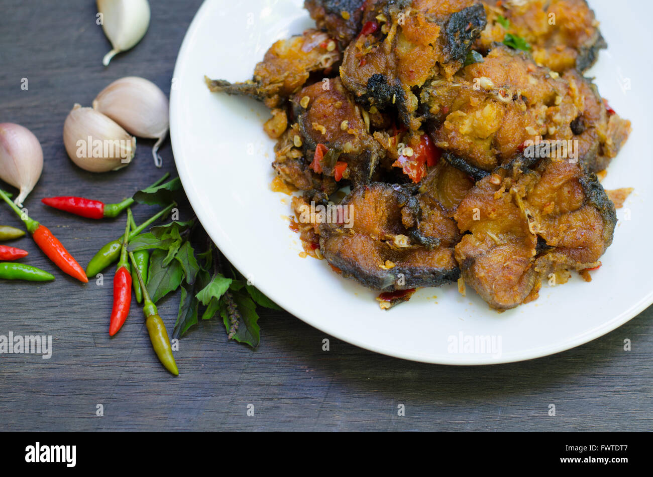 Spicy Stir Fried catfish on dish Stock Photo