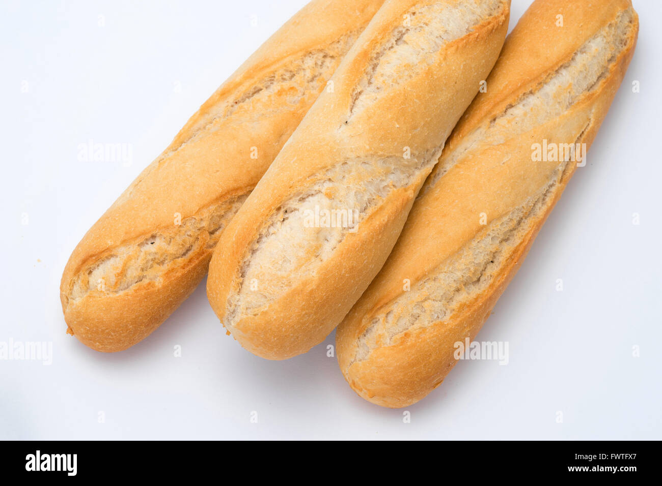 Crusty bread rolls or buns on a white background Stock Photo