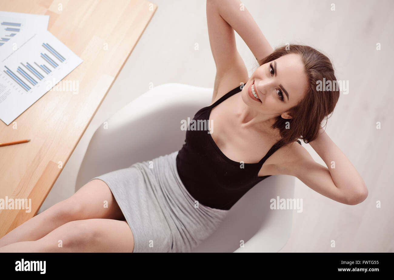 Attractive woman in chair table hi-res stock photography and images - Alamy