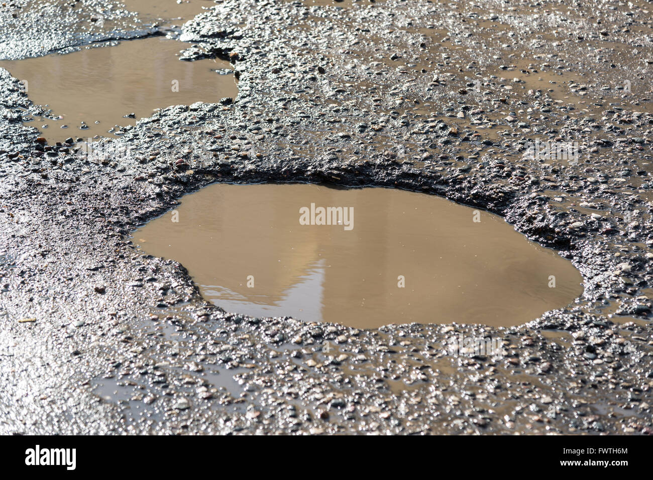 Potholes on asphalt road filled with water Stock Photo Alamy