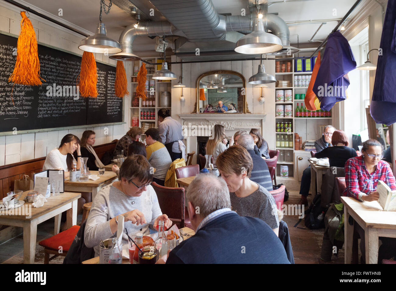 Customers eating inside Bills Restaurant, Reading, Berkshire UK Stock Photo