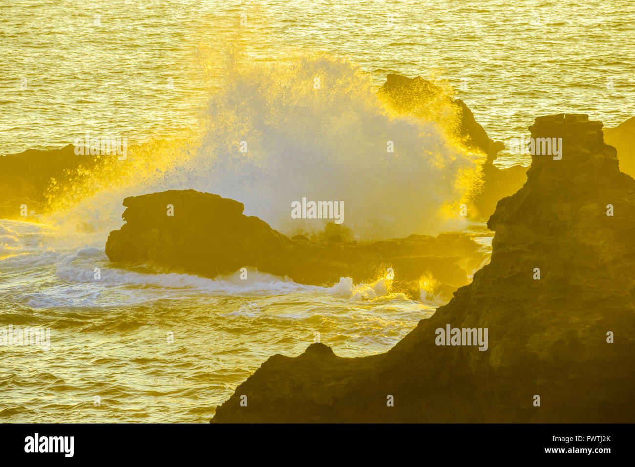Waves crashing on rocks in Poelua Bay, Maui Stock Photo