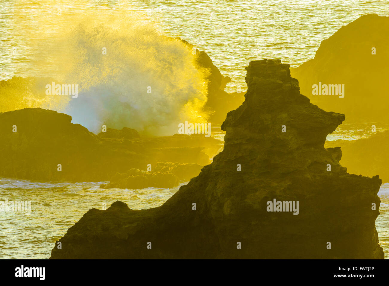 Waves crashing on rocks in Poelua Bay, Maui Stock Photo