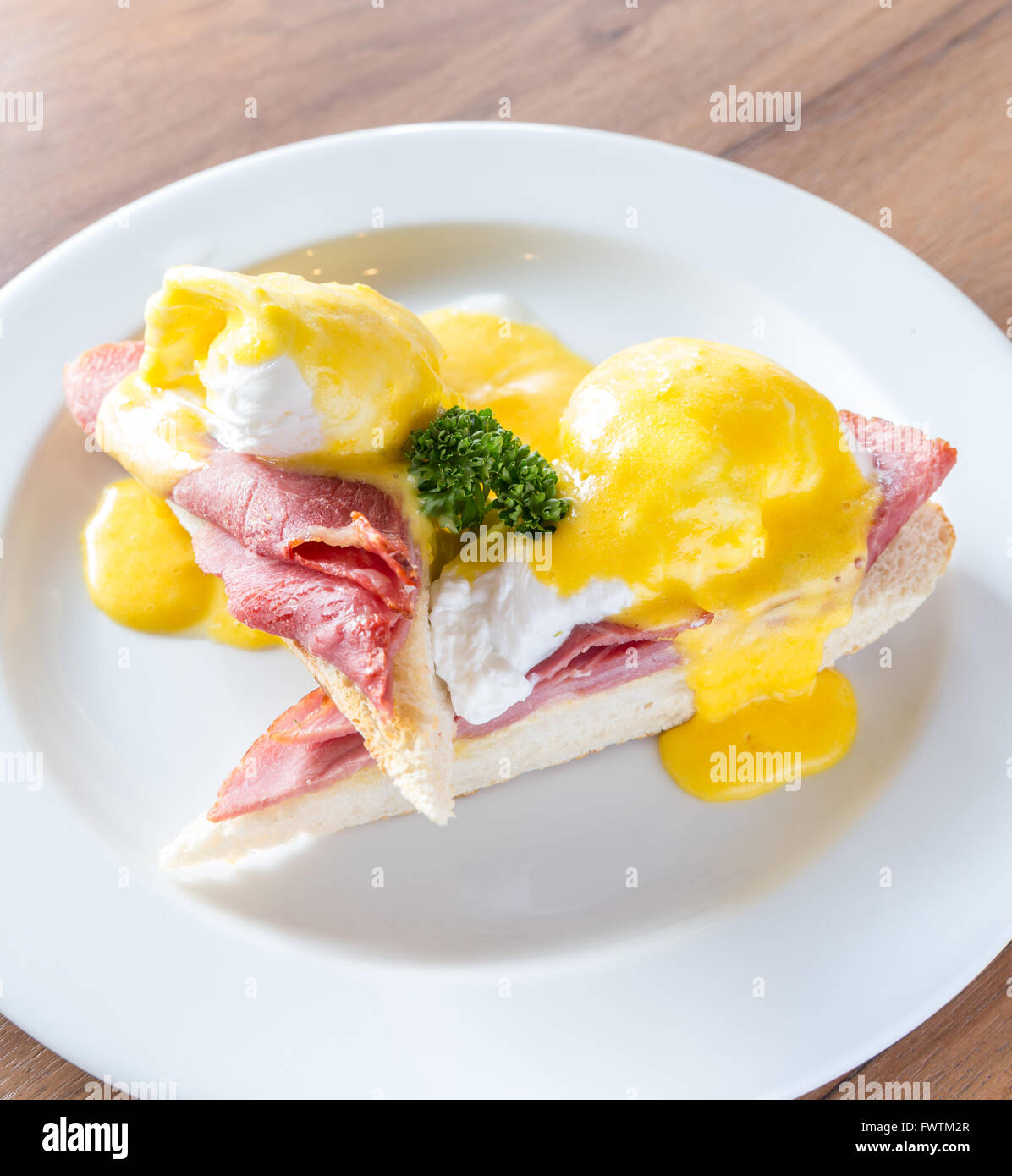 Eggs Benedict breakfast toasted English muffins, ham, poached eggs