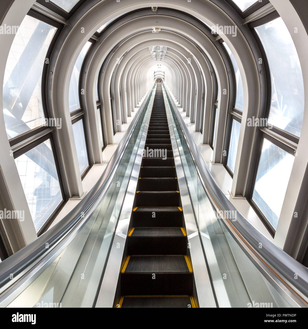 perspective escalators stairway inside contemporary blue glass business