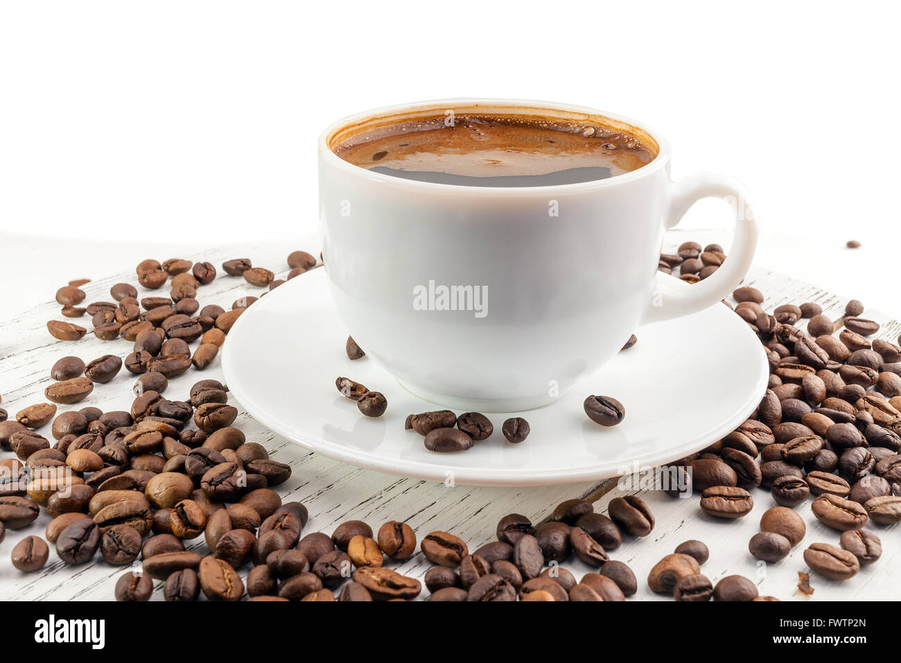Coffee cup and beans on a white background Stock Photo - Alamy
