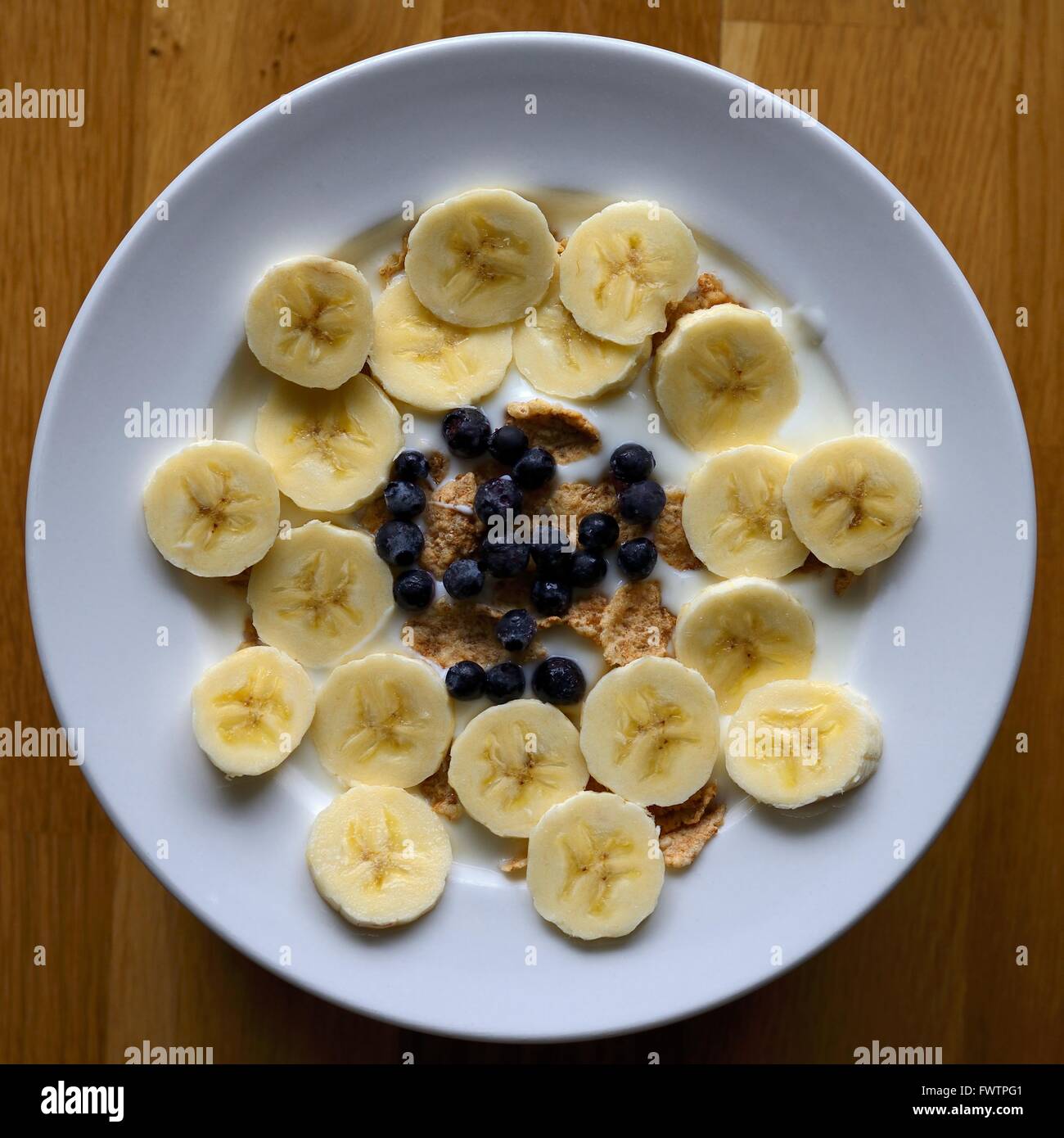 Breakfast cereal with fruit on a wood background Stock Photo