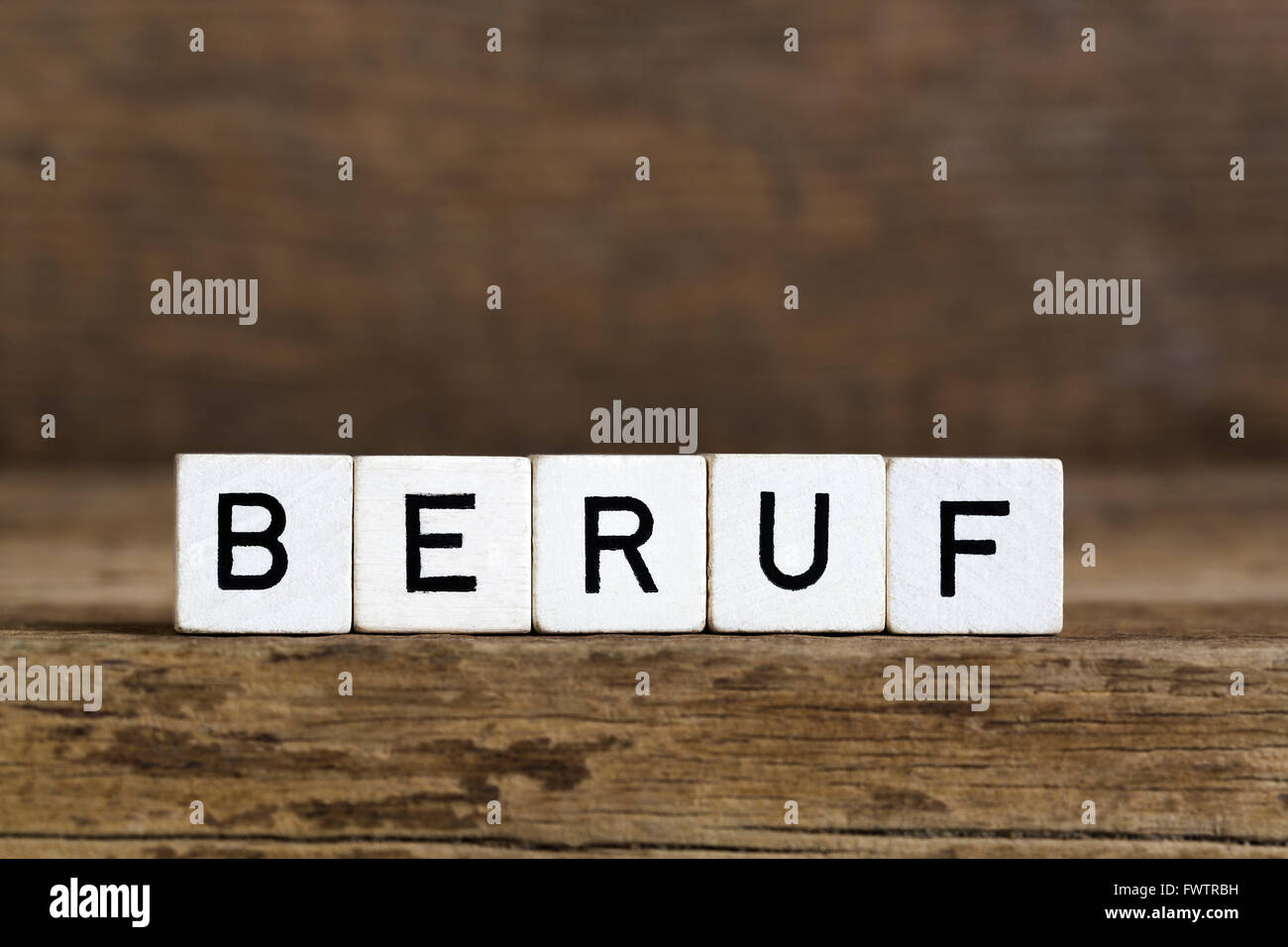 The German word profession written in cubes on wooden background Stock Photo