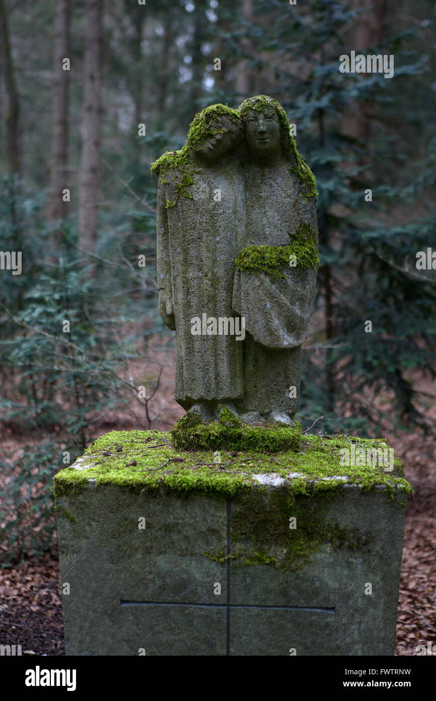 Overgrown grave stones at a cemetery Stock Photo