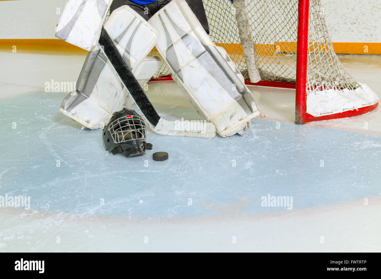A Hockey Goalie Readies Himself in the Crease and Net Before Game in Rink Stock Photo